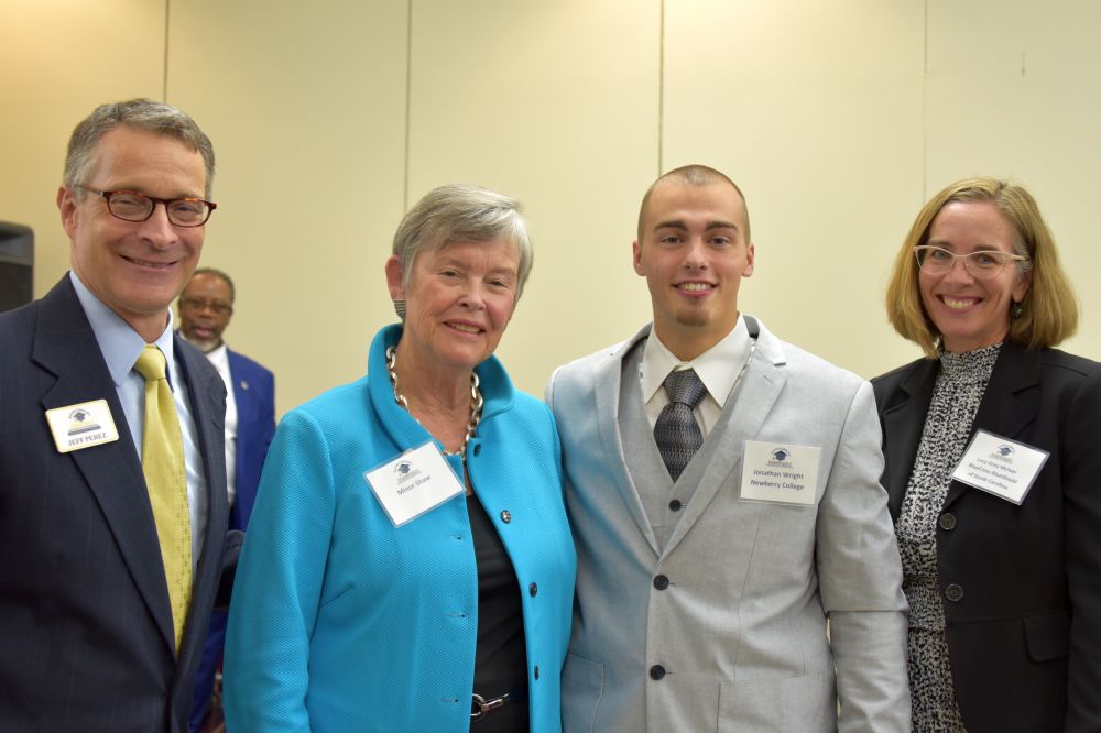 SCICU Student of the Year Jonathan Wright is congratulated by SCICU President Jeff Perez, SCICU Life Trustee Minor Mickel Shaw, and SCICU Board Chair Lucy Grey McIver.