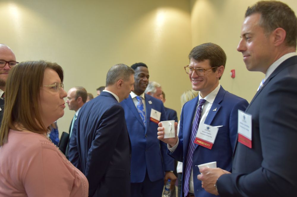 During meet-and-greet time before the start of SCICU's Oct. 13 board meeting, S.C. Tuition Grants Executive Director Katie Harrison talks with Converse President Boone Hopkins and Presbyterian College President Matt vandenBerg.