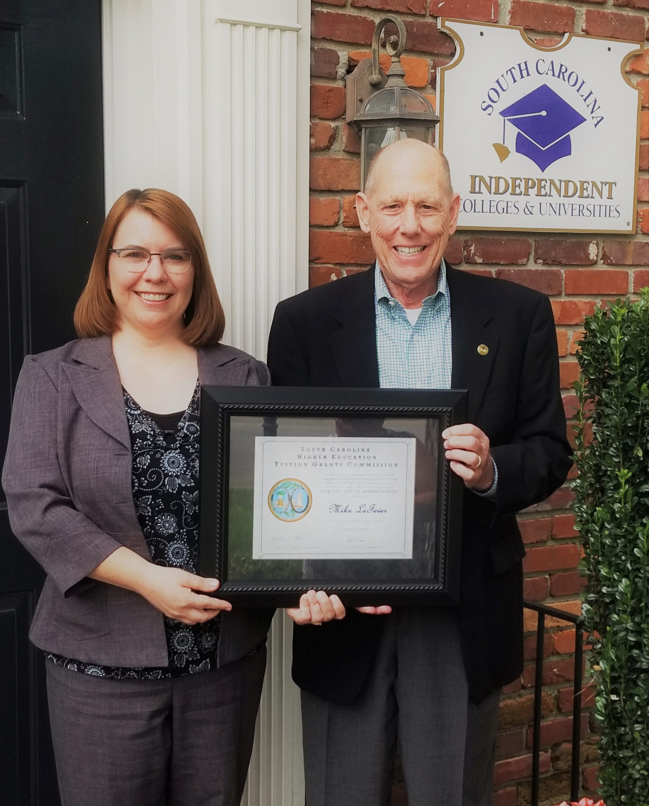 Katie Harrison, Executive Director of the SC Tuition Grants Commission, presented a Certificate of Appreciation to SCICU President and CEO Mike LeFever at the commission's June board meeting.