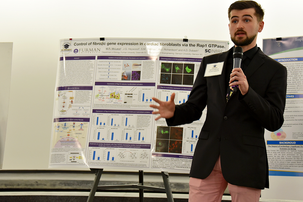 Furman University student researcher Michael McLeod presents his research findings at the Feb. 16, 2023 SCICU Research Symposium hosted by Milliken and Company.